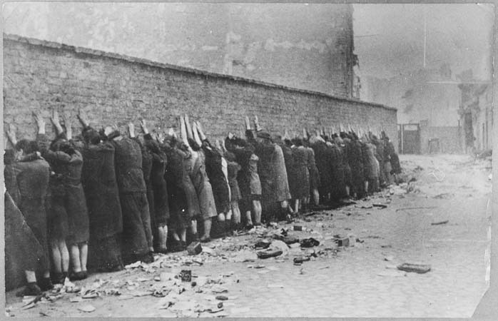 Jews lined up against the wall, the Warsaw Ghetto